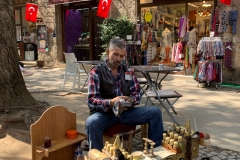 A shoe polisher at work in Bursa's Koza Han.